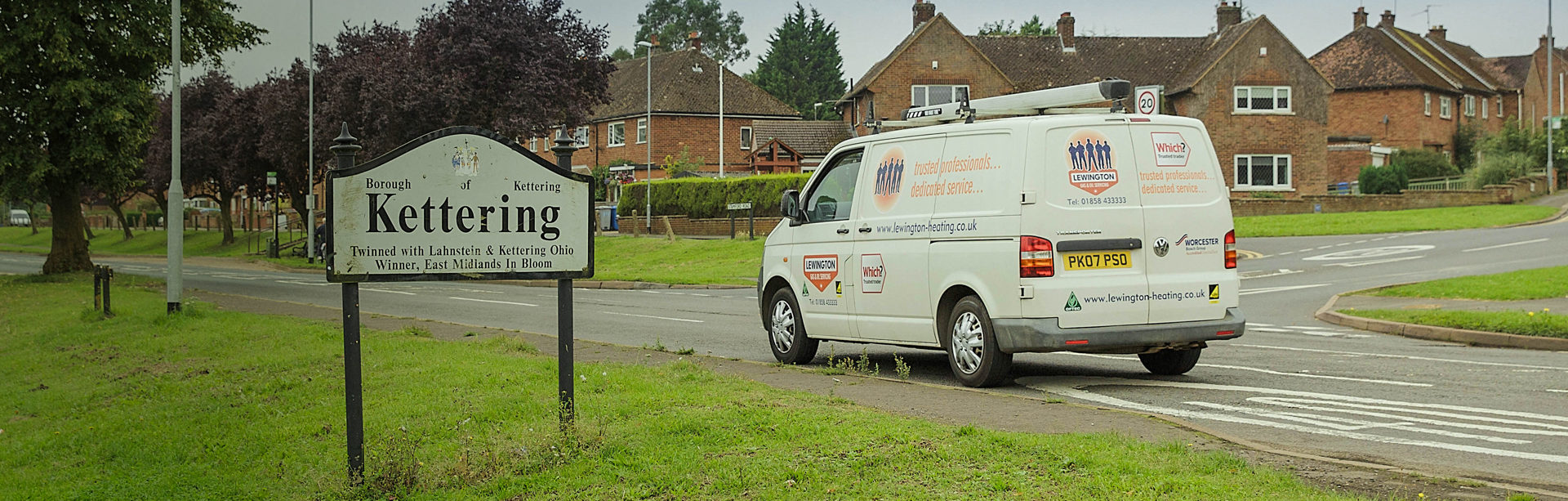 White plumbers van driving into Kettering