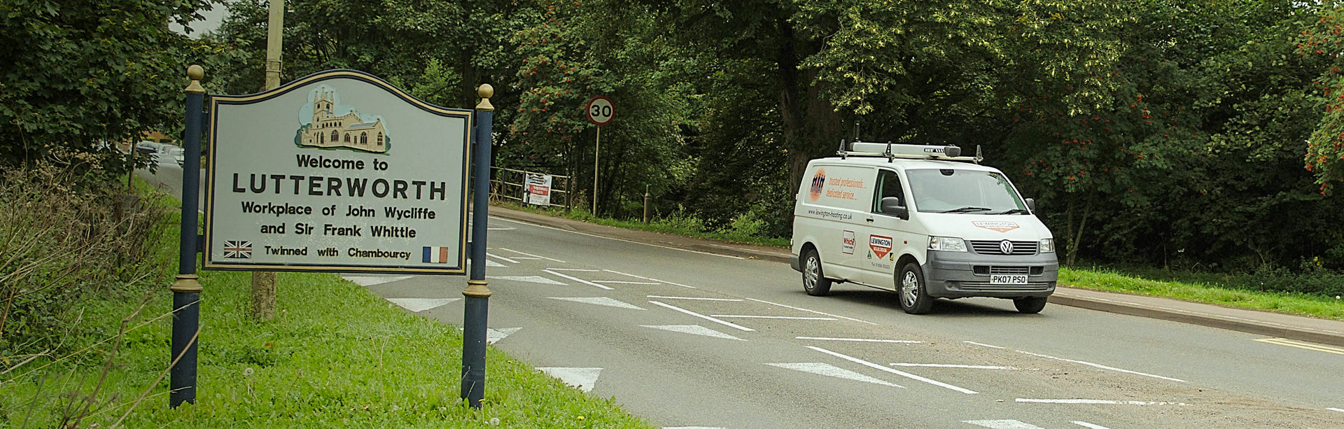 White plumbers van driving into Lutterworth